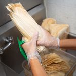 Dried corn husks are soaked in water before being used to wrap tamales. <br />